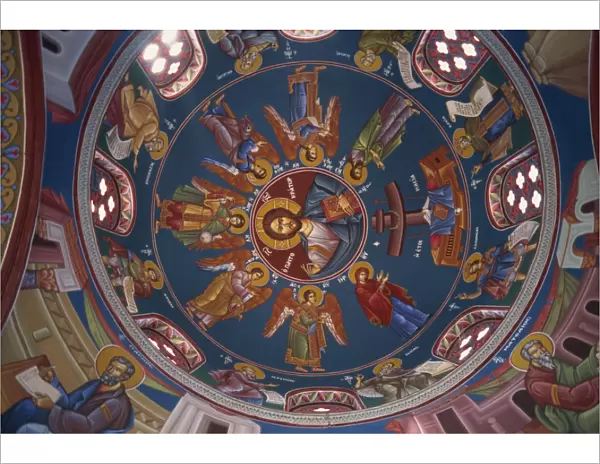 Paintings of Christian figures including Christ, in vibrant colours on the ceiling of the dome in the interior of St. Georges Church in Paphos, west of the island, Cyprus