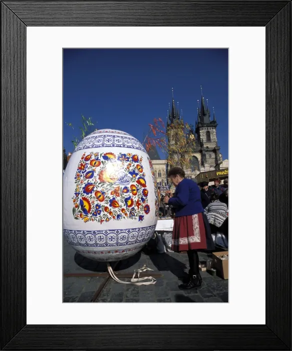 Framed Print : A Moravian woman decorating a large egg with Easter designs on the Old Town Square Framed Print : A Moravian woman decorating a large egg with Easter designs on the Old Town Square