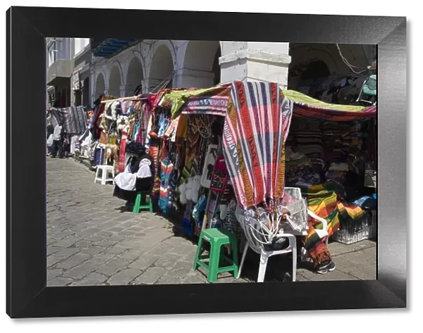 Colourful clothing and textiles for tourists in the market on Plaza San Francisco