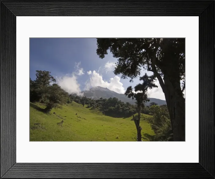 Framed Print : Smoke rises from the active crater of Tungurahua Volcano that threatens the nearby town of Banos Framed Print : Smoke rises from the active crater of Tungurahua Volcano that threatens the nearby town of Banos