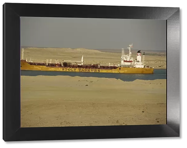 Tanker passing through Suez Canal with desert on either side, Egypt, North Africa, Africa