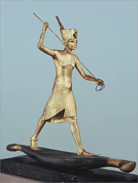 Gilt wood statuette of Tutankhamun on a boat with a harpoon, from the tomb of the pharaoh Tutankhamun, discovered in the Valley of the Kings, Thebes, Egypt, North