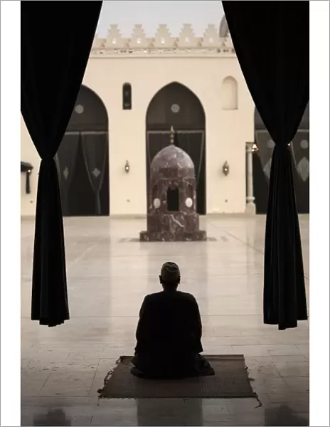Man praying at the Mosque of Al-Hakim, Cairo, Egypt, North Africa, Africa