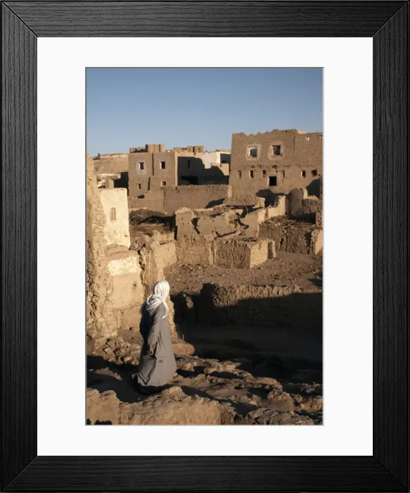 Framed Print : A man stands among the ruin of the mud-brick city of Al-Qasr, Dakhla Oasis Framed Print : A man stands among the ruin of the mud-brick city of Al-Qasr, Dakhla Oasis