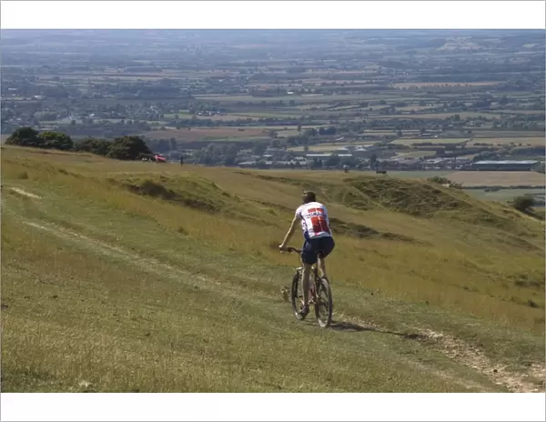 Mountain biker on public bridleway, Cleeve Hill, The Cotswolds, Gloucestershire
