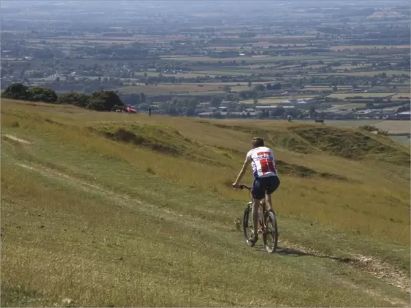 Mountain biker on public bridleway, Cleeve Hill, The Cotswolds, Gloucestershire