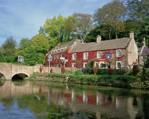 The Swan Hotel reflected in the river at Bibury in the Cotswolds, Gloucestershire