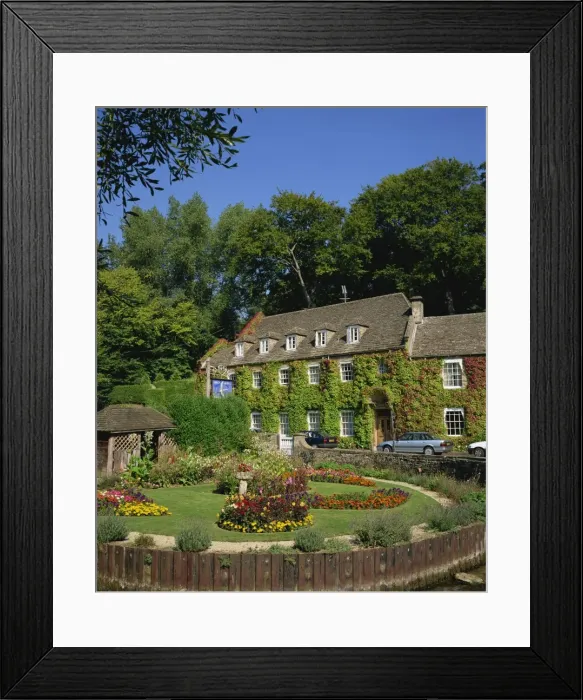 Framed Print : The Swan Hotel and garden full of summer flowers at Bibury, in the Cotswolds Framed Print : The Swan Hotel and garden full of summer flowers at Bibury, in the Cotswolds