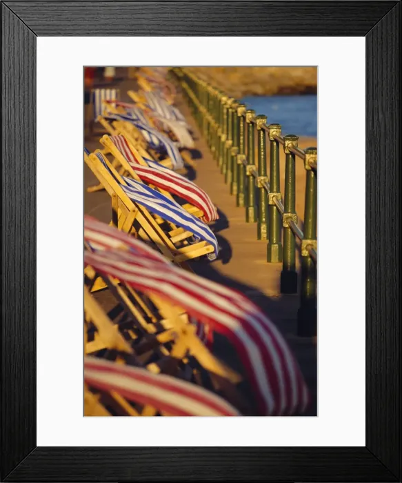 Framed Print : Windblown deckchairs on seafront, Sidmouth, Devon, England Framed Print : Windblown deckchairs on seafront, Sidmouth, Devon, England