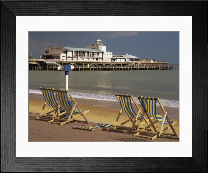 Framed Print : Deckchairs on the Promenade overlooking the deserted beach and Pier Theatre early in the summer season, West Cliff, Bournemouth, Dorset, England, United Framed Print : Deckchairs on the Promenade overlooking the deserted beach and Pier Theatre early in the summer season, West Cliff, Bournemouth, Dorset, England, United
