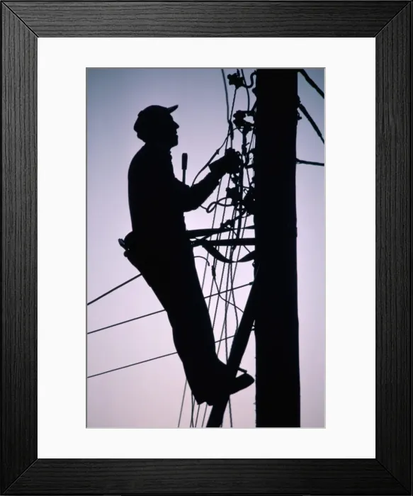 Framed Print : Silhouette of engineer working up a telegraph pole, East Sussex, England Framed Print : Silhouette of engineer working up a telegraph pole, East Sussex, England