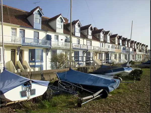 Sailing boats and holiday homes on the seafront, Whitstable, Kent, England