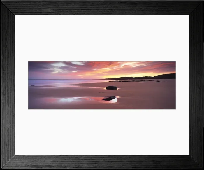 Framed Print : View along Embleton Bay at sunrise, with silhouette of Dunstanburgh Castle in the distance Framed Print : View along Embleton Bay at sunrise, with silhouette of Dunstanburgh Castle in the distance