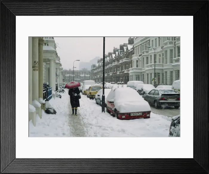 Framed Print : Woman with umbrella and cars covered in snow in winter in West Kensington Framed Print : Woman with umbrella and cars covered in snow in winter in West Kensington