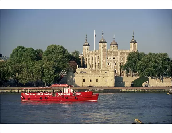 Sightseeing boat on the River Thames, and the Tower of London, UNESCO World Heritage Site