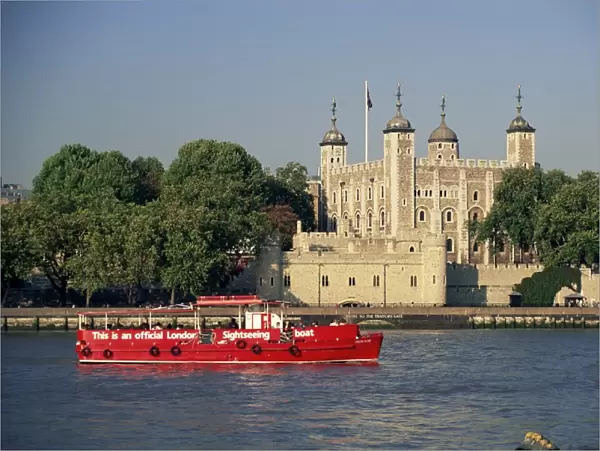 Sightseeing boat on the River Thames, and the Tower of London, UNESCO World Heritage Site