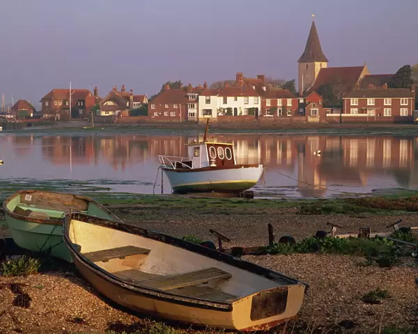 Boats in Bosham from across the tidal creek in early morning, on one of the small inlets of Chichester Harbour, Bosham, West Sussex, England, United