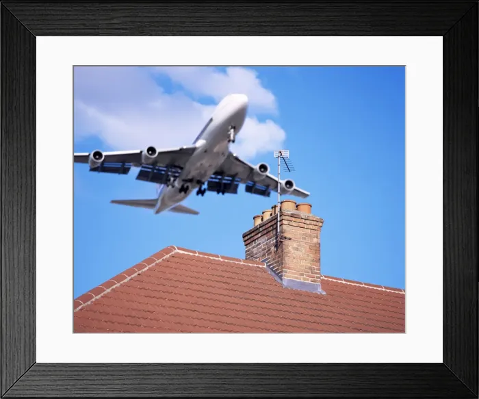 Framed Print : Low-flying aircraft over rooftops near London Heathrow Airport, Greater London Framed Print : Low-flying aircraft over rooftops near London Heathrow Airport, Greater London