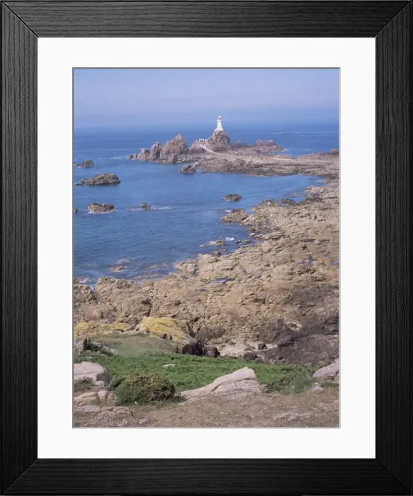 Framed Print : Lighthouse from cliffs at low tide, Corbiere, St. Brelade, Jersey, Channel Islands