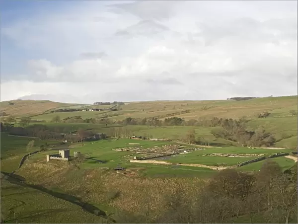 Looking west over Roman settlement and fort, Vindolanda, with the Roman Wall on the skyline