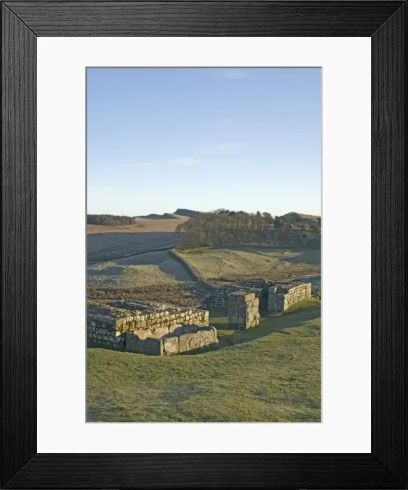 Framed Print : North gateway to Housesteads Roman Fort, stone water storage tank in foreground Framed Print : North gateway to Housesteads Roman Fort, stone water storage tank in foreground