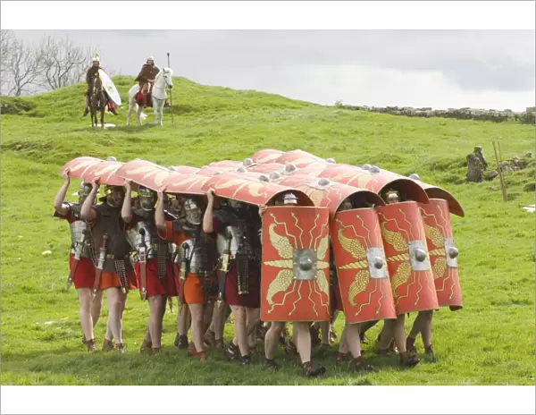 Ermine Street Guard advancing with protective shields, cavalry in attendance