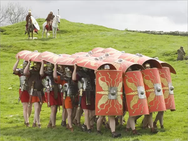 Ermine Street Guard advancing with protective shields, cavalry in attendance