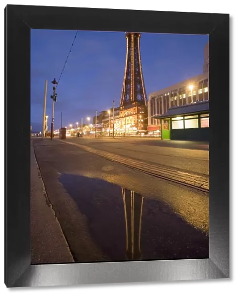 Blackpool Tower reflected in puddle at dusk, Blackpool, Lancashire, England