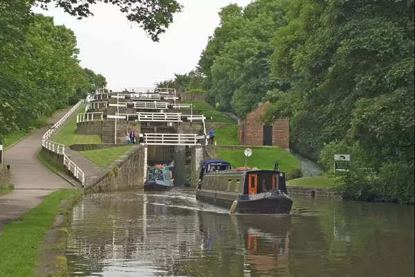Narrow boats on the Liverpool Leeds canal, negotiating the five lock ladder at Bingley