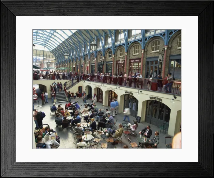 Framed Print : High angle view of people sitting at tables at cafes in the interior of the covered market place at Covent Garden, London, England, United Framed Print : High angle view of people sitting at tables at cafes in the interior of the covered market place at Covent Garden, London, England, United