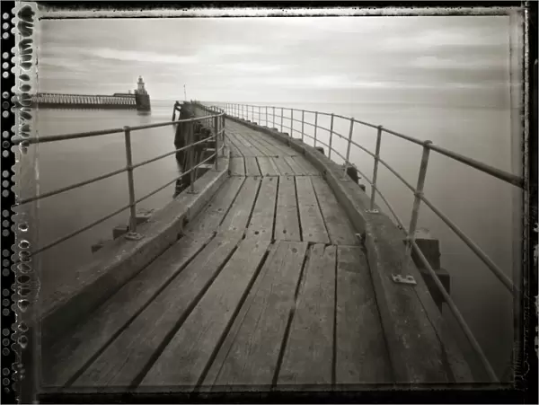 Pinhole camera image of view along timber walkway of Blyth Pier towards lighthouse