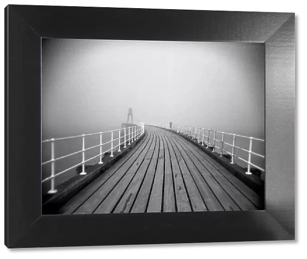 Image taken with a Holga medium format 120 film toy camera looking along timber boardwalk of Whitby pier on misty winters day, Whitby, North Yorkshire, England, United