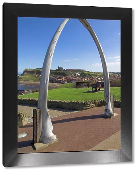 Whalebone arch on Seafront, with Whitby abbey ruin in distance, Whitby