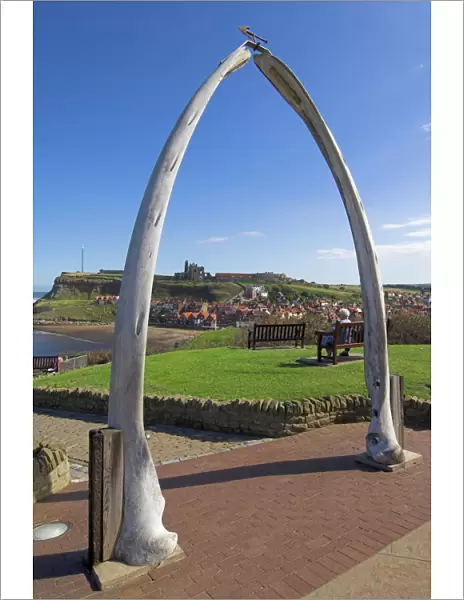 Whalebone arch on Seafront, with Whitby abbey ruin in distance, Whitby