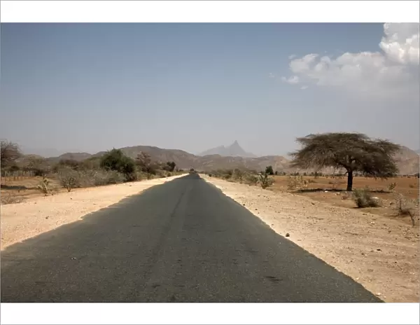 An empty road and the barren landscape of western Eritrea, Africa