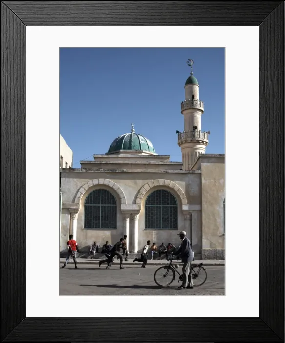 Framed Print : Kids play football behind the Great Mosque (Kulafuh Al Rashidin) in the center of Asmara Framed Print : Kids play football behind the Great Mosque (Kulafuh Al Rashidin) in the center of Asmara