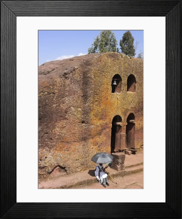 Framed Print : Pilgrim sitting reading Holy Bible in the courtyard of Bet Maryam church (St Framed Print : Pilgrim sitting reading Holy Bible in the courtyard of Bet Maryam church (St