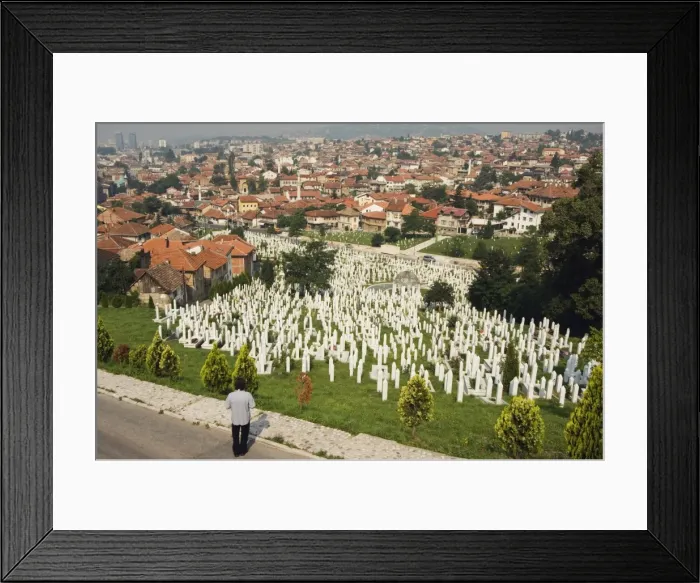 Framed Print : Man reflecting at cemetery overlooking city houses, Sarajevo, Bosnia, Bosnia-Herzegovina Framed Print : Man reflecting at cemetery overlooking city houses, Sarajevo, Bosnia, Bosnia-Herzegovina