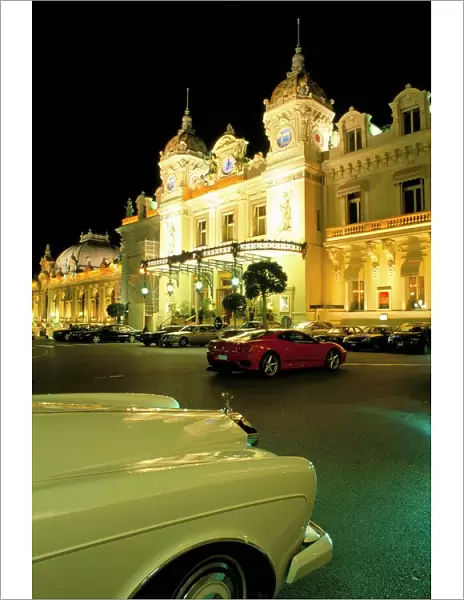 Rolls Royce and Ferrari parked in front of the Casino at night, Monte Carlo
