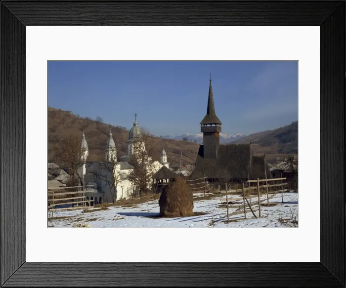 Framed Print : Haystack in snow covered field with two churches in the background at Botita village Framed Print : Haystack in snow covered field with two churches in the background at Botita village
