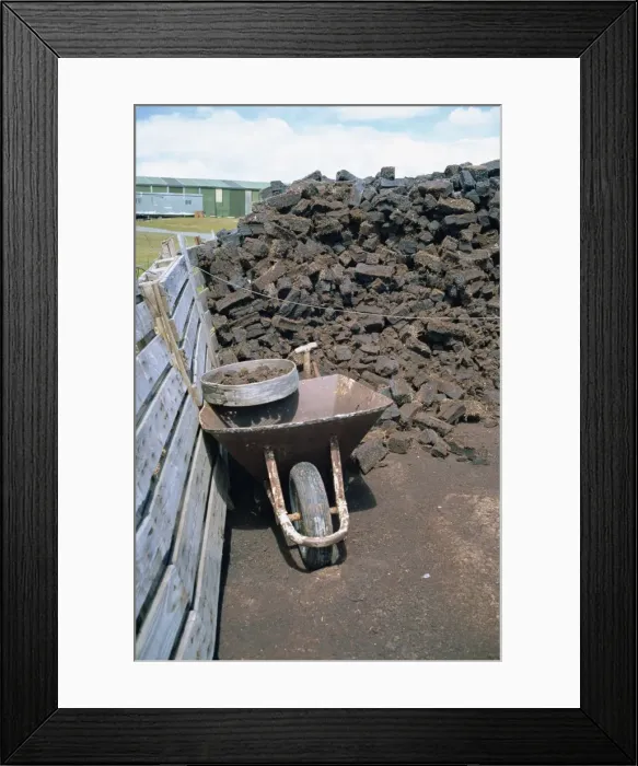 Framed Print : Wheelbarrow and peat stack at a settlement on the Falkland Islands, South America Framed Print : Wheelbarrow and peat stack at a settlement on the Falkland Islands, South America