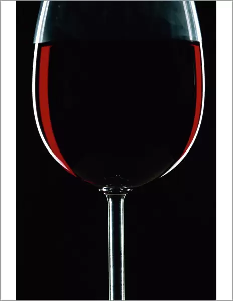 Backlit shot of a glass of red wine