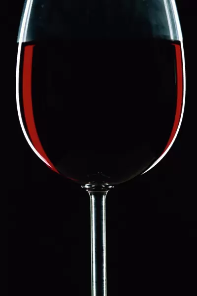 Backlit shot of a glass of red wine