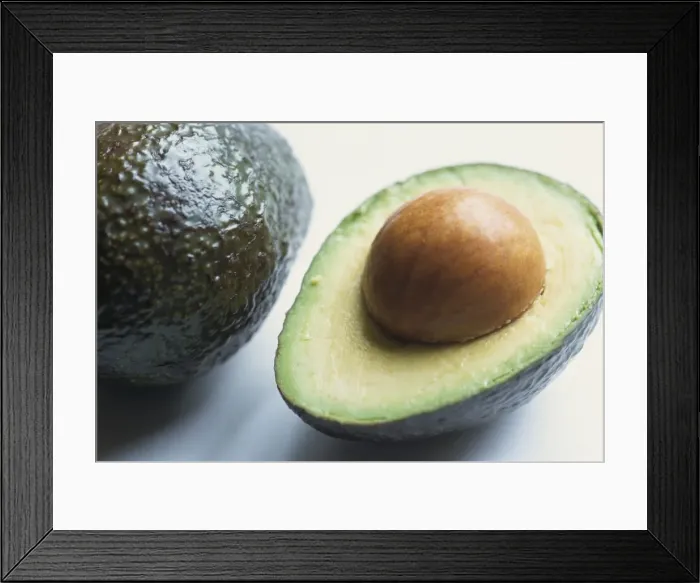 Framed Print : Close-up of half an avocado pear, with stone Framed Print : Close-up of half an avocado pear, with stone