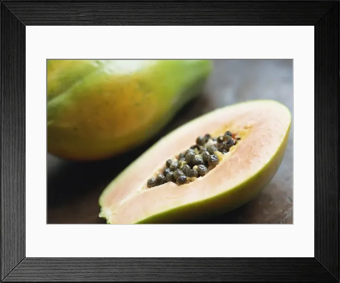 Framed Print : Close-up of a papaya sliced in half showing black seeds inside Framed Print : Close-up of a papaya sliced in half showing black seeds inside