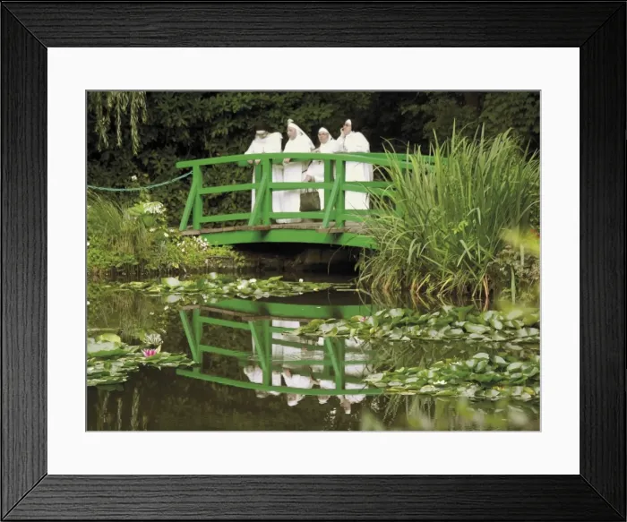 Framed Print : Four nuns standing on the Japanese bridge in the garden of the Impressionist painter Claude Monet Framed Print : Four nuns standing on the Japanese bridge in the garden of the Impressionist painter Claude Monet