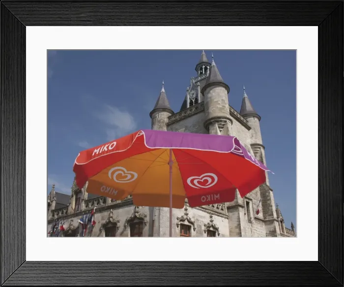 Framed Print : Umbrella advertising ice cream, with Gothic town hall behind, Rue, Somme Framed Print : Umbrella advertising ice cream, with Gothic town hall behind, Rue, Somme