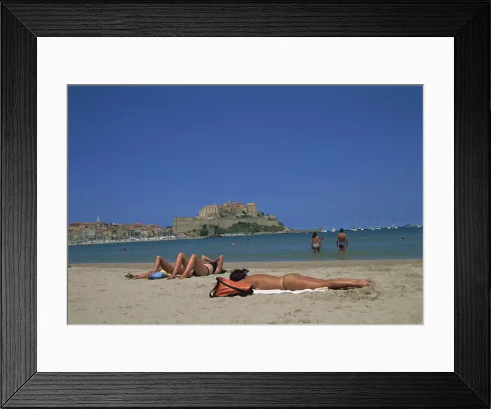 Framed Print : Tourists sunbathing on beach near Calvi, Balagne region, Corsica, France, Europe Framed Print : Tourists sunbathing on beach near Calvi, Balagne region, Corsica, France, Europe