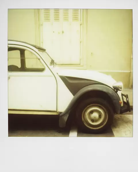 Polaroid of old black and white Citroen 2CV parked on street, Paris, France, Europe