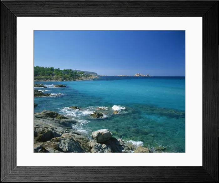 Framed Print : Distant view to the Ile de la Pietra, across calm turquoise sea from Ile-Rousse Framed Print : Distant view to the Ile de la Pietra, across calm turquoise sea from Ile-Rousse